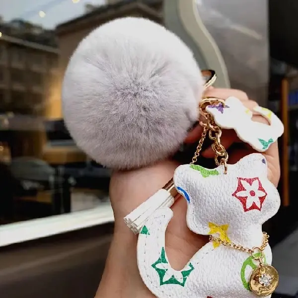 White flowers + fur balls,chaincharmsupply.com
