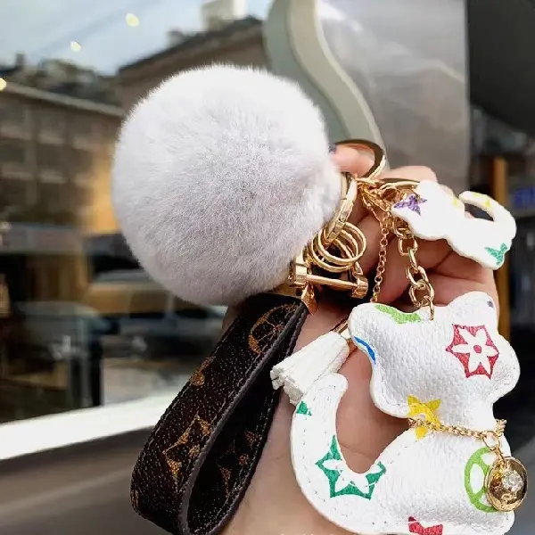 White flower + keychain + hair ball,chaincharmsupply.com